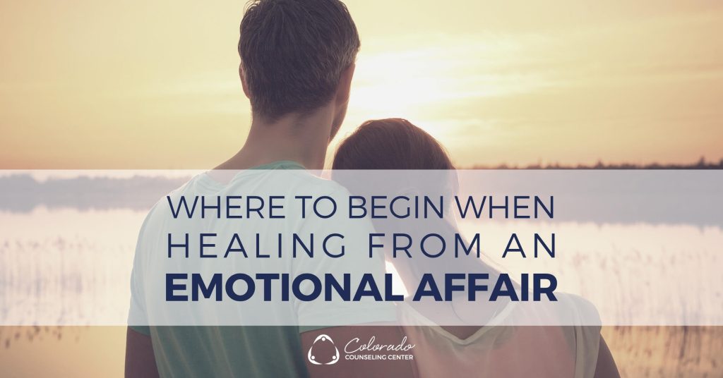 Couple sitting together outdoors at sunset, beginning to heal from an emotional affair