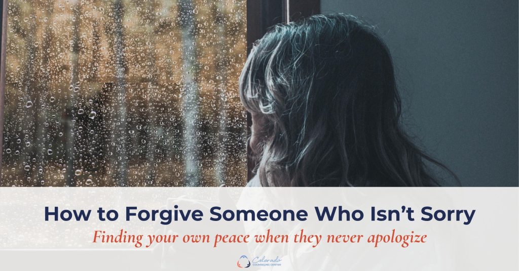 Woman sitting alone at a rain-streaked window, reflecting on forgiveness when someone isn't sorry
