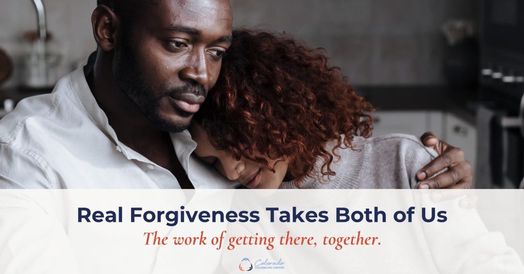 Man and woman embracing tenderly in a kitchen, working through true forgiveness together in their relationship