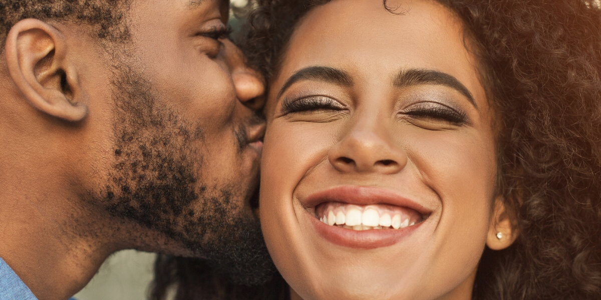 Spouse smiling joyfully &mdash; marriage counseling in Greenwood Village and Centennial helps couples rediscover happiness and closeness