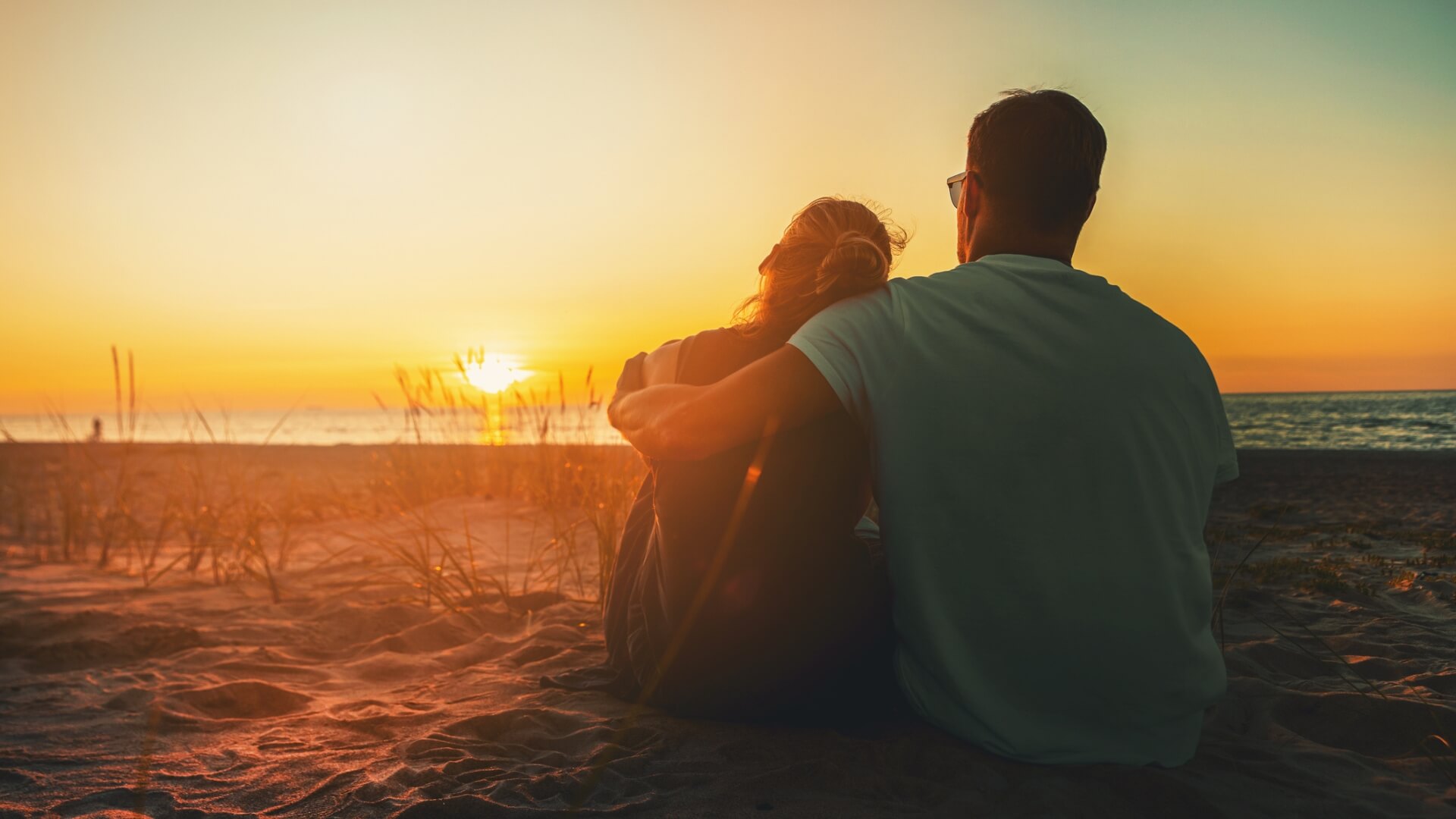 Peaceful couple watching sunset, representing healing through couples counseling